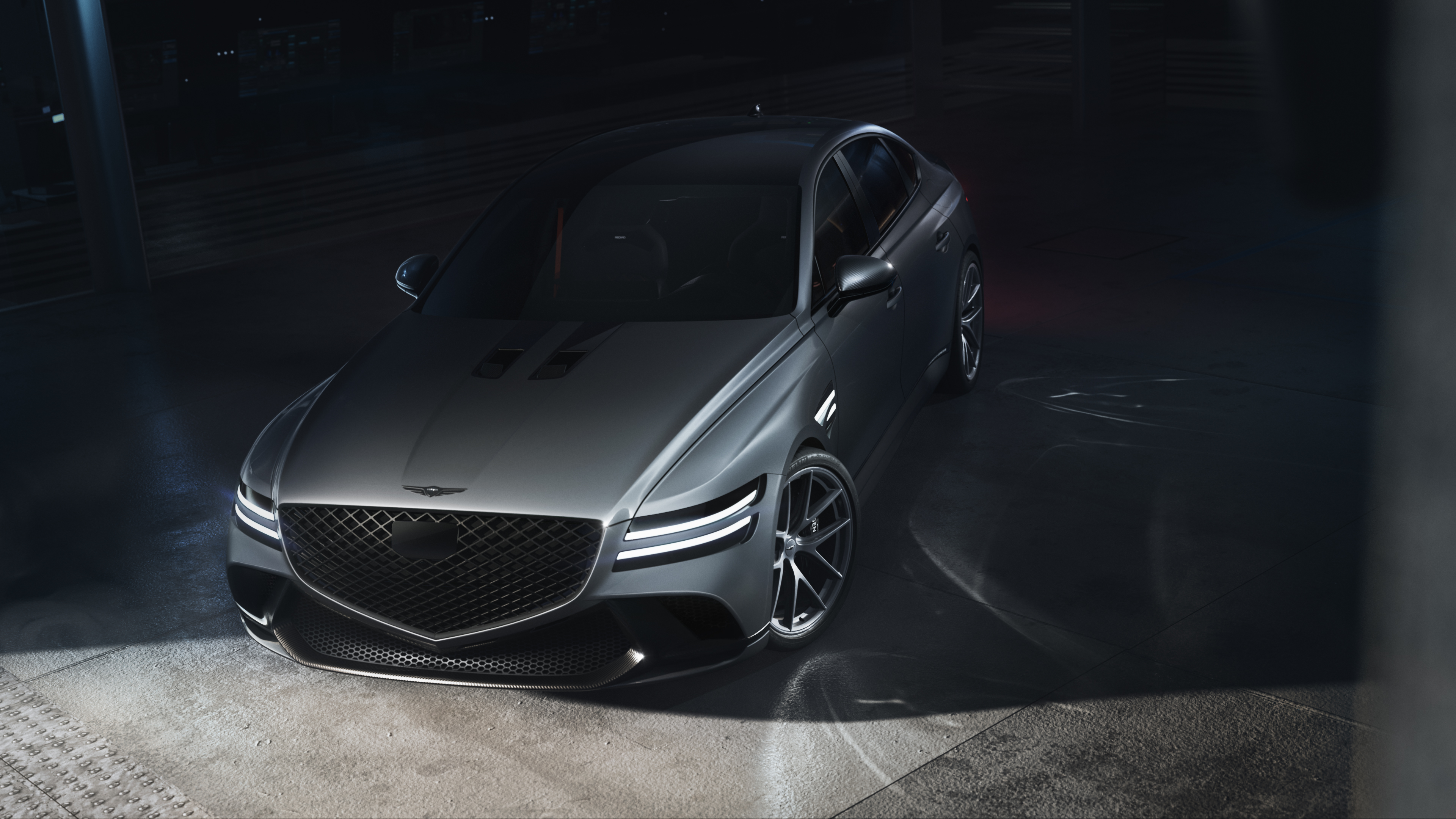Silver Genesis G80 in a dramatically lit garage